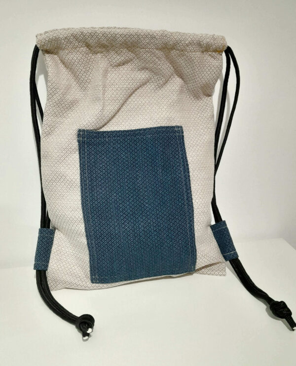 unisex backpack cream color padding cloth with blue poket